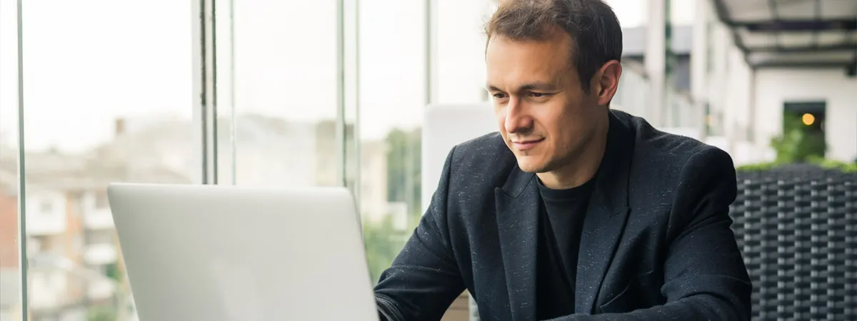 Professional Businessman Checking Laptop Cafe Smiling